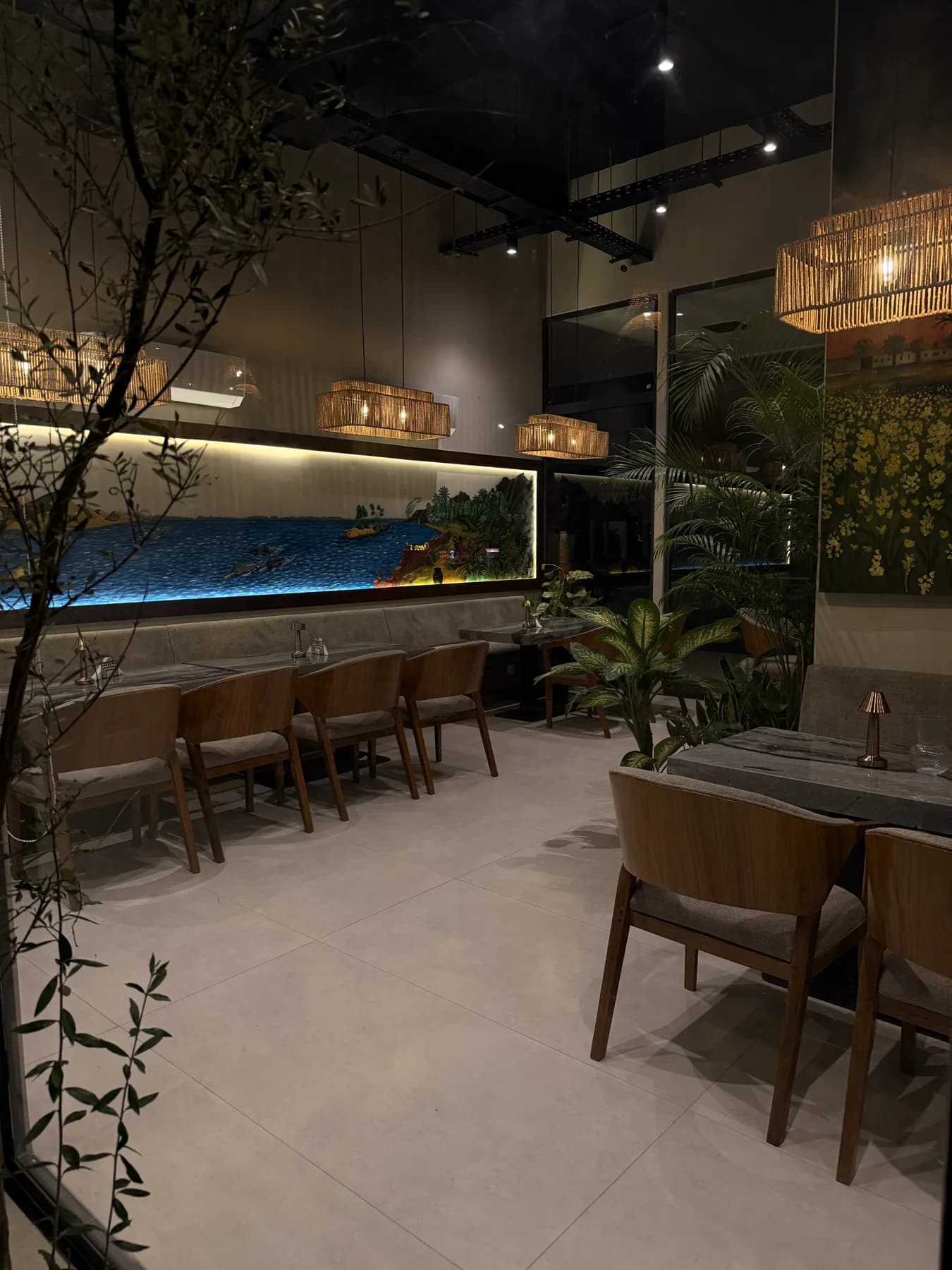The dining room in the evening, looking along the banquette